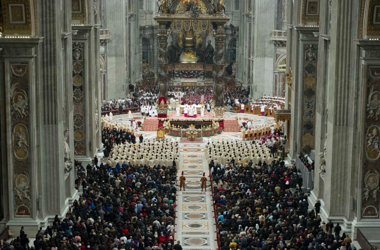 Worshippers gathered for Mass inside St. Peter's Basilica in Vatican City, with the altar illuminated and clergy processing through the nave